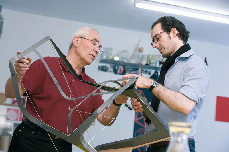 Martin Plank Sr. and Konstantin Grcic holding an early MYTO prototype